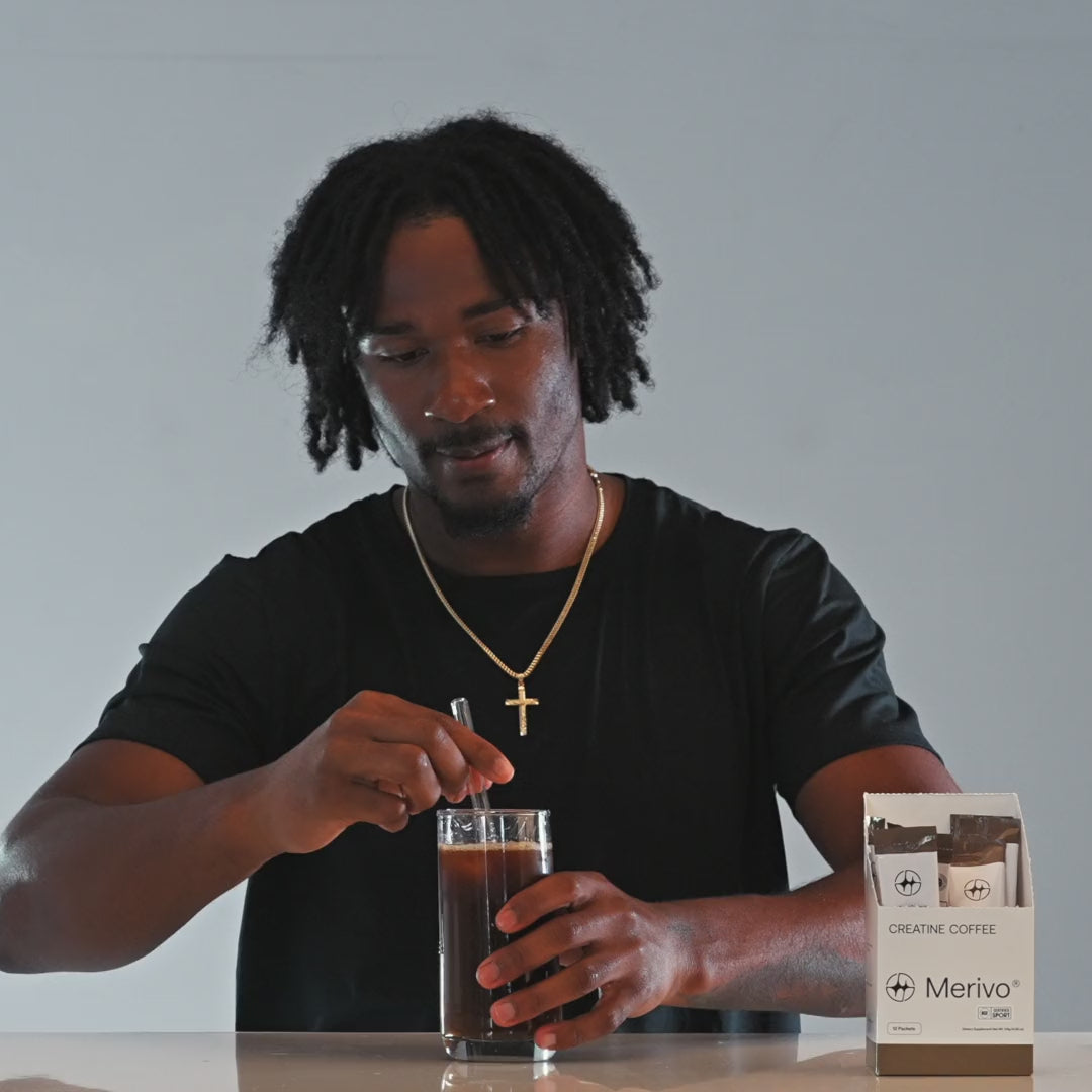 Tory Horton drinking an iced Merivo Creatine Coffee beside the box.