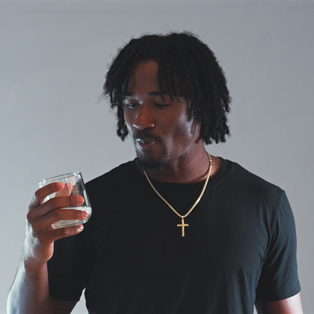 Tory Horton drinking Merivo Lemon Creatine from a glass of cold water.