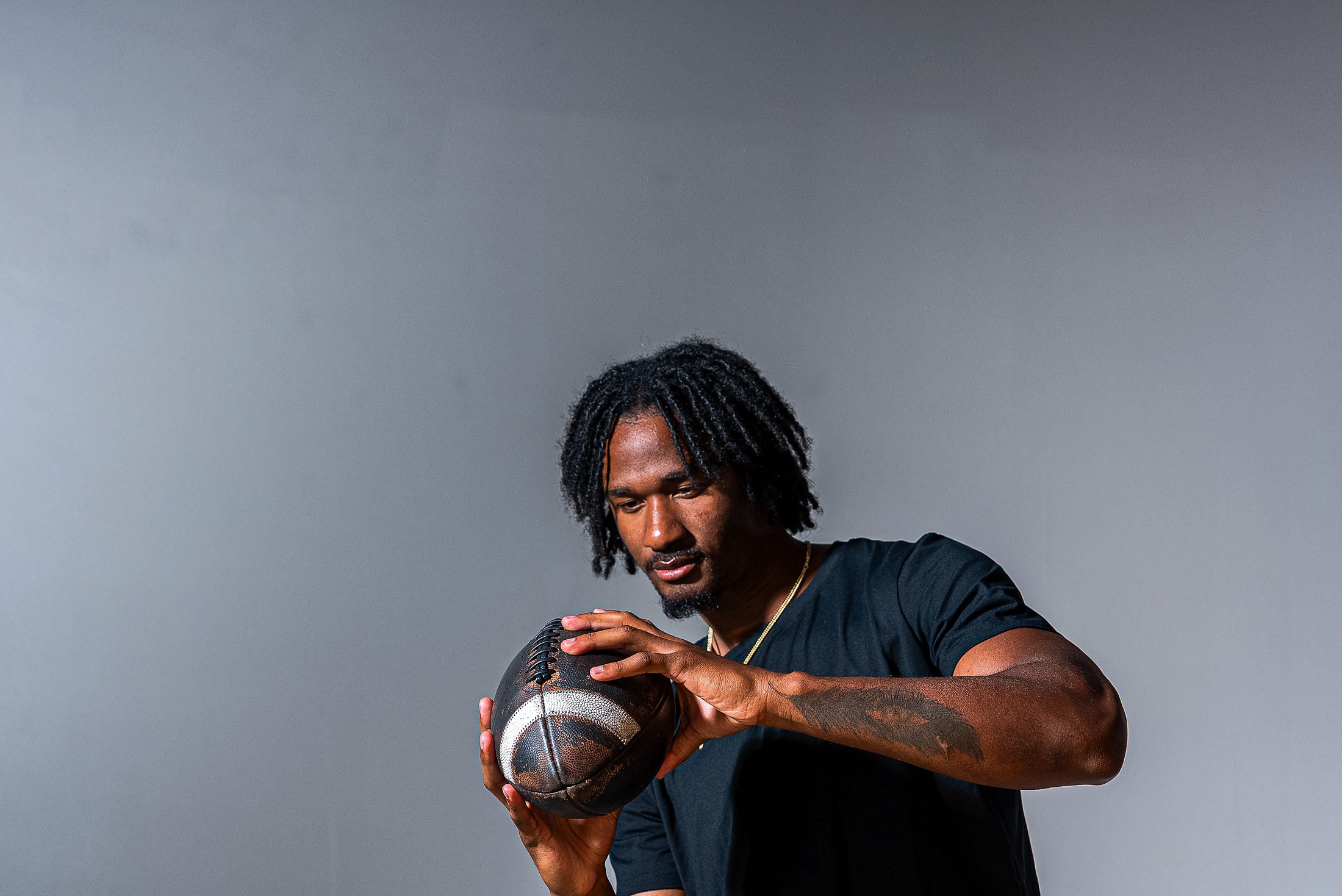 Tory Horton holding a football