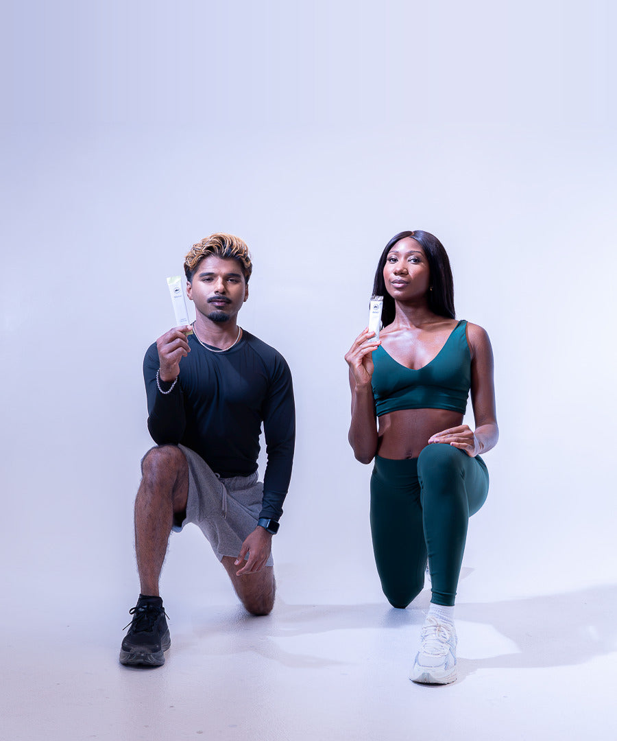 Two athletes kneeling side by side, each holding a Merivo stick pack.