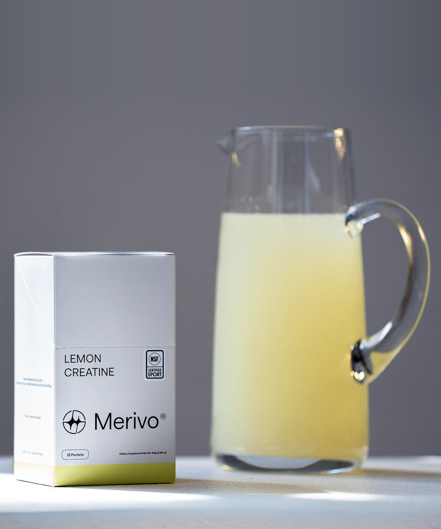 A Merivo Lemon Creatine box beside a glass pitcher of lemonade.
